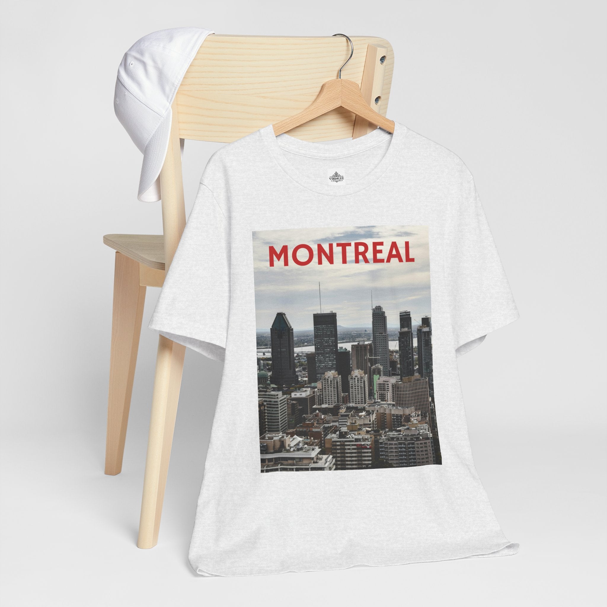 White t-shirt with Montreal skyline graphic on a wooden chair