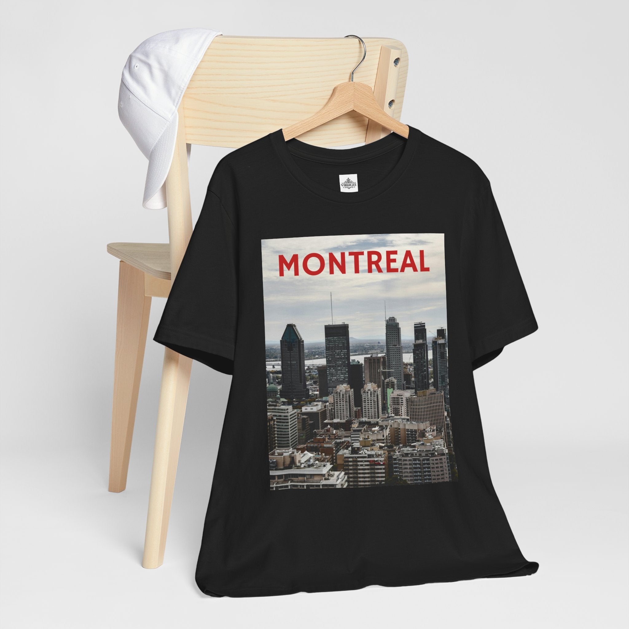 Black t-shirt with Montreal cityscape graphic on a wooden chair