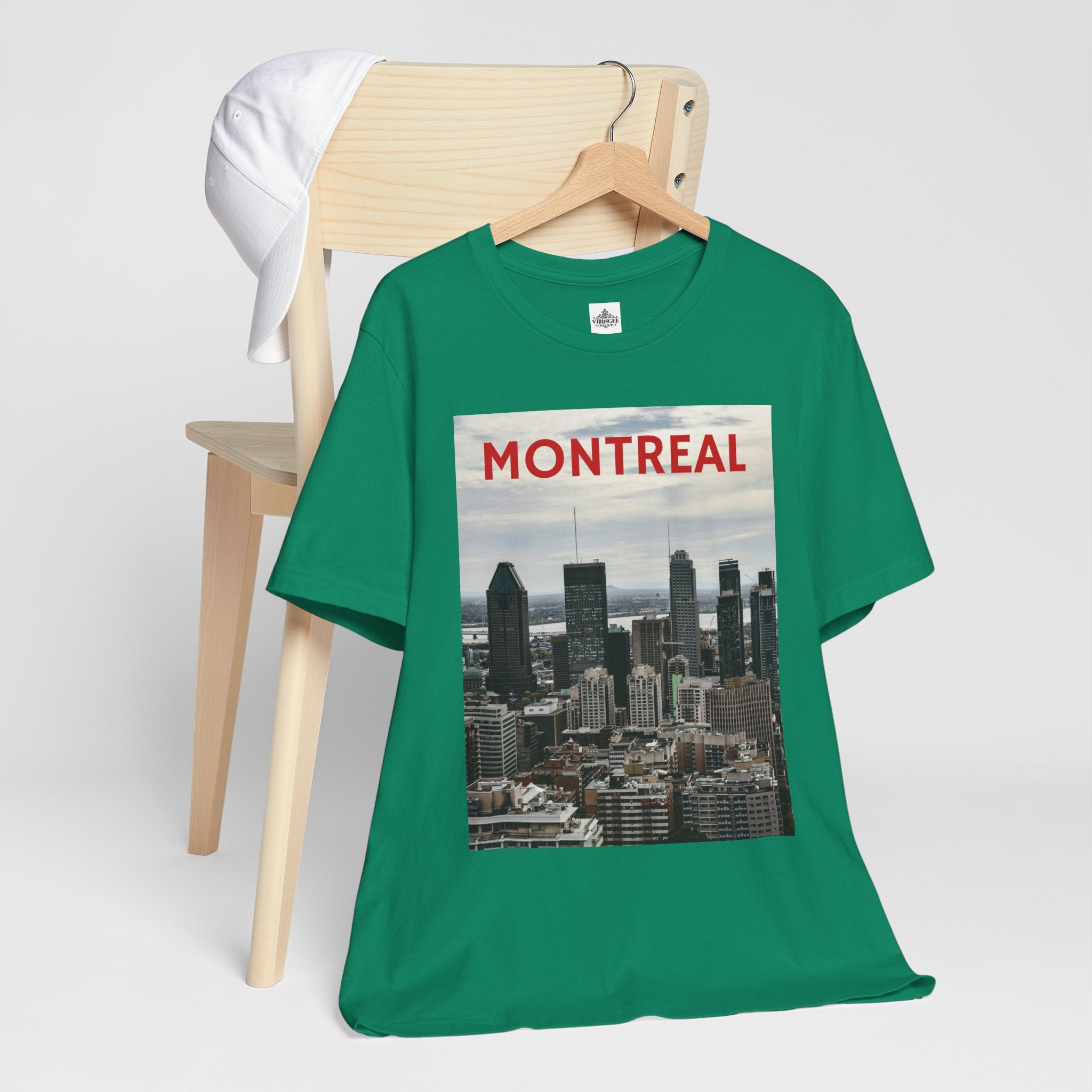 Green t-shirt with Montreal skyline graphic on a wooden chair
