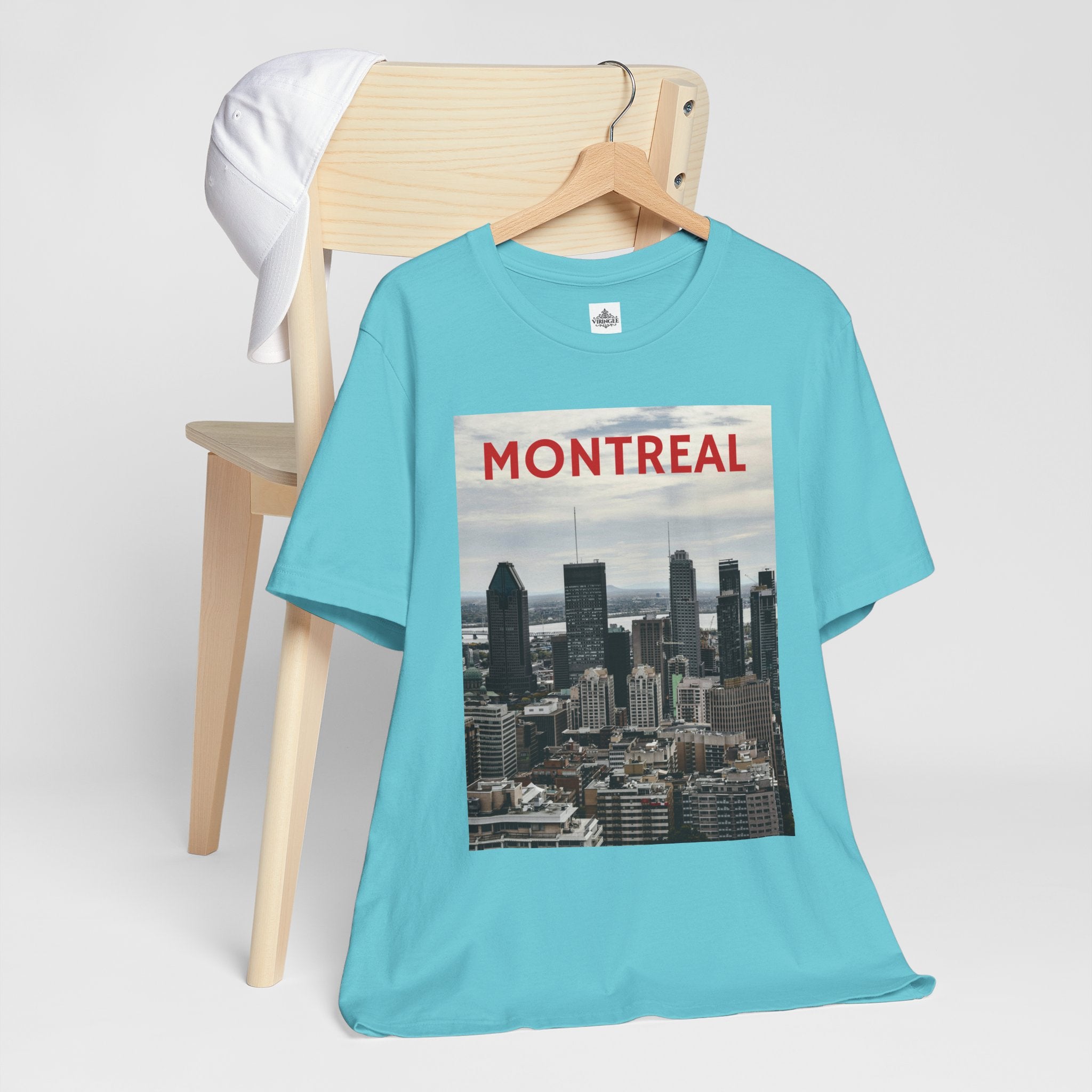 Turquoise t-shirt with Montreal skyline graphic on a wooden chair
