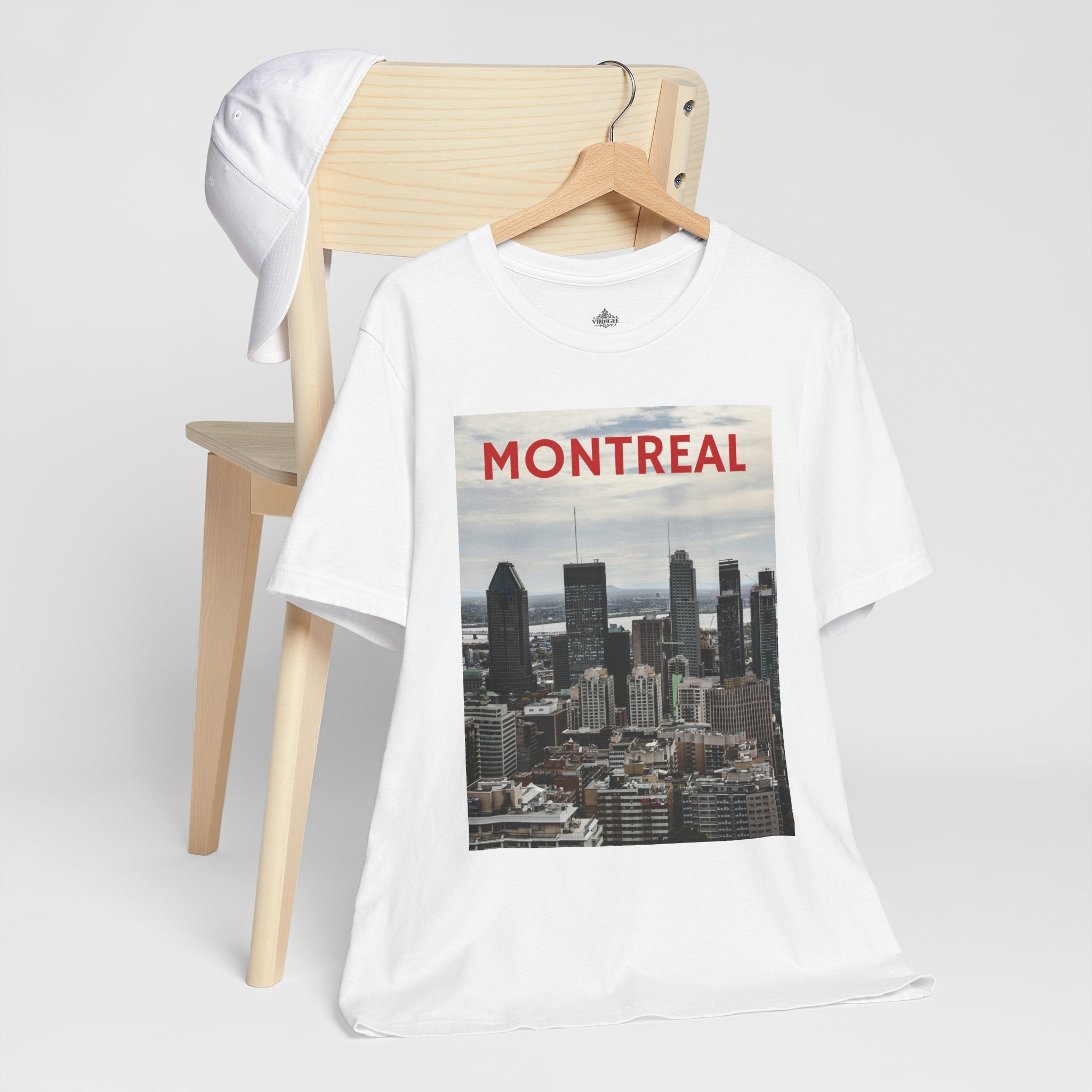 White t-shirt with Montreal skyline graphic on a wooden chair